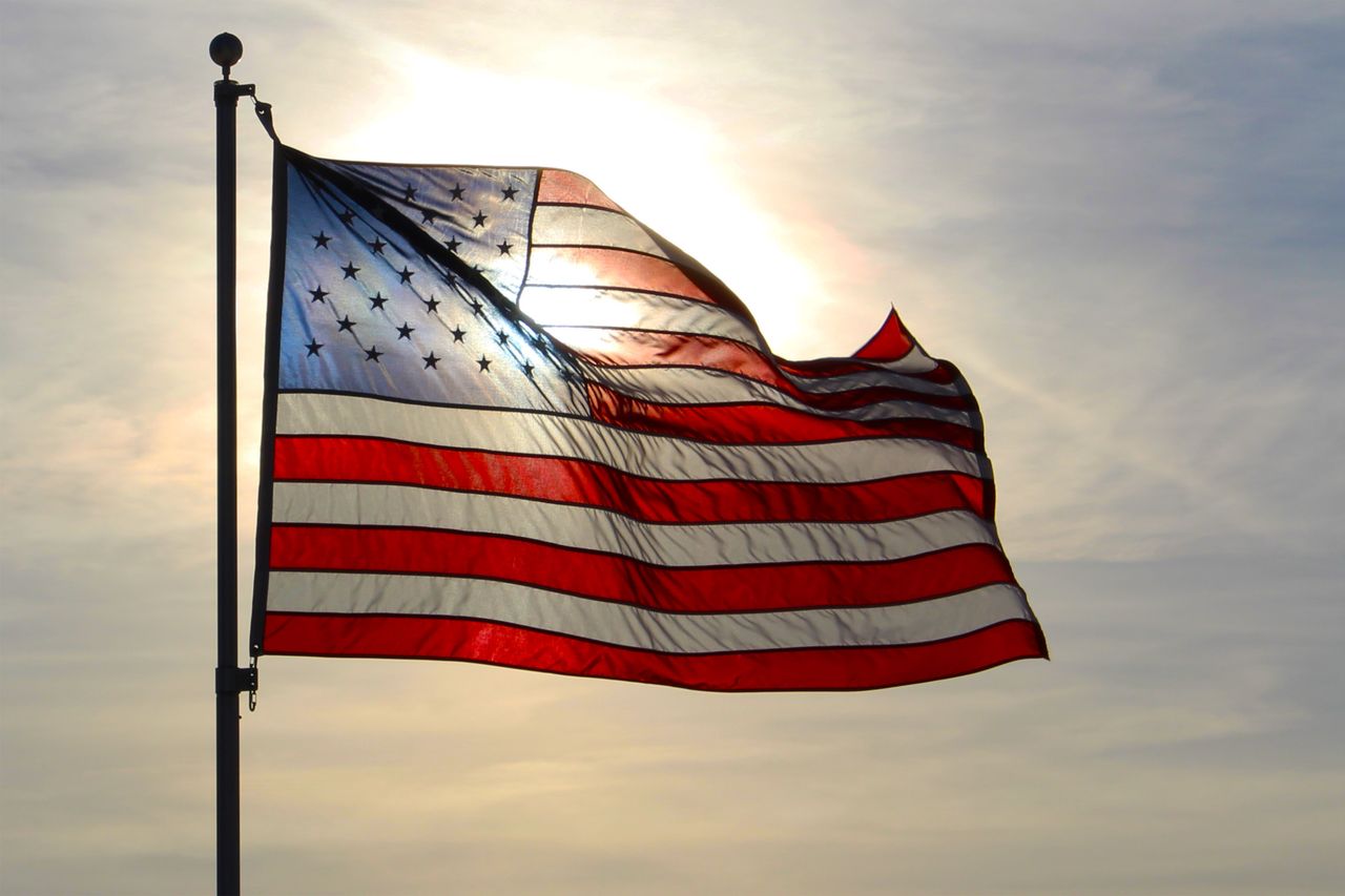 An American flag waving at sunrise